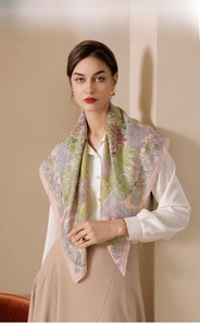 Detailed view of floral print silk scarf with refined pink stitched edges on model