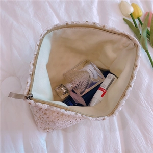 Detailed internal view of white lace makeup bag showing organized cosmetics storage