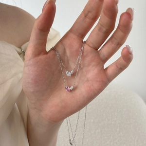 Detailed view of S925 silver necklace with pink and clear pear-cut heart gemstones