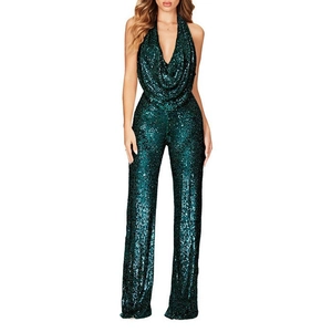 Detail of emerald green sequin jumpsuit featuring a deep V-neck and halter design