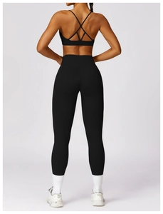 Detail view of high waist yoga leggings with lift effect and cross back sports bra set