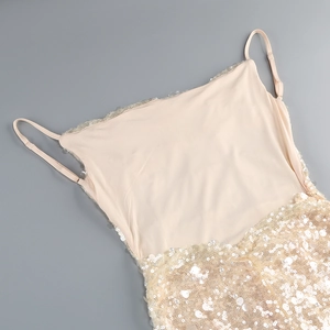 Detail of adjustable straps and sequin texture on champagne gold fishtail evening gown