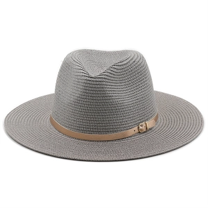 Close-up of grey straw fedora hat featuring woven texture and brown leather strap with buckle