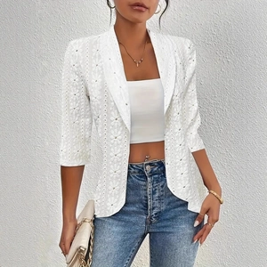 Detail of elegant white lace blazer featuring intricate floral patterns and classic lapels