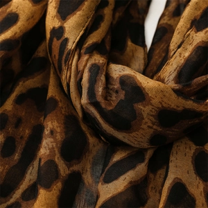 Close-up of leopard print scarf fabric showing soft brown and black pattern texture