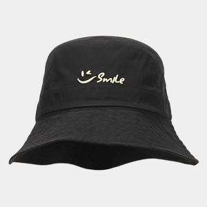 Detail of Smile lettering and winking graphic on thin black quick-dry bucket hat