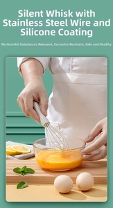 Macro view of silicone coated manual whisk whisking egg liquid in a glass bowl