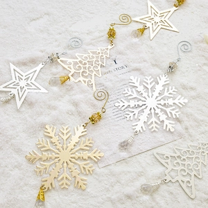 Golden and silver metal snowflake and Christmas tree ornaments with crystal beads