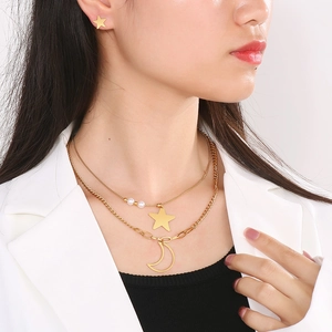 Chic gold-plated star earrings and layered crescent moon pendant necklace set on model