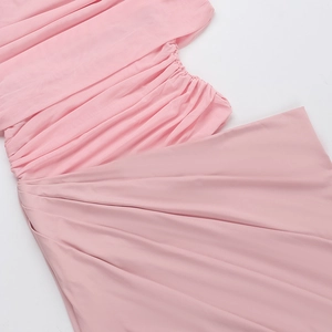 Detail of pink pleated fabric showing delicate texture and elegant drape of the dress