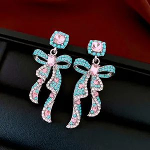 Vintage style silver bow earrings with pink crystals and turquoise blue beads for women
