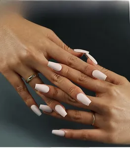 Detail view of matte nude pink coffin-shaped press-on nails for a natural look