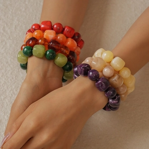 Close-up of colorful acrylic resin bead bracelets with marble texture on model wrist