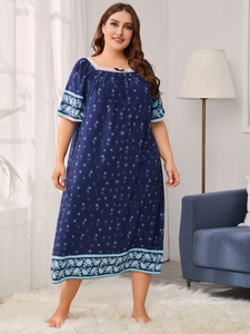 Close-up of square lace neckline and bow detail on navy floral plus size nightdress