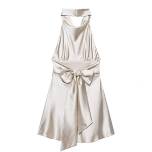 Detail of champagne silk halter dress with waist bow and elegant satin texture