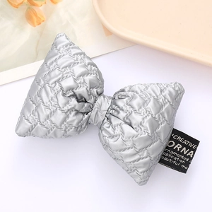 Quilted silver textured leather bow accessory with 3D padded design for fashion decor