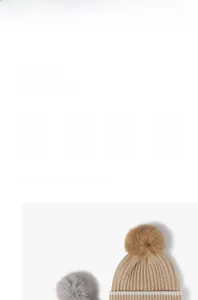 Close-up of thick ribbed knit texture and fluffy faux fur pom-pom on winter beanies