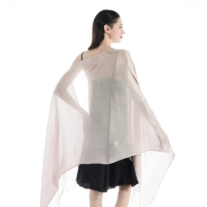 Close-up of champagne shimmer wrap scarf featuring delicate tassel fringe and sparkling fabric
