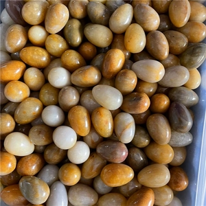 Macro shot of polished egg-shaped natural agate and quartz stones in assorted colors