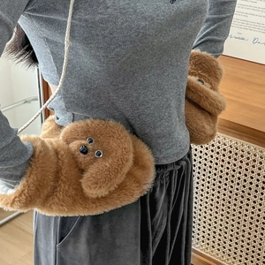 Detail of plush teddy dog mittens with fluffy faux fur texture and white woven lanyard