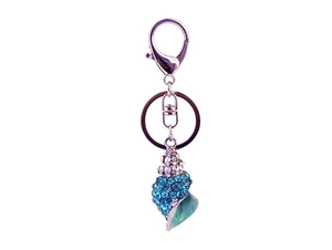 Detailed macro view of silver conch keychain with blue rhinestones and lobster clasp