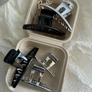 Minimalist large shark hair clips in silver and black colors shown in gift box packaging