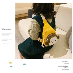 Rear view of a child wearing a yellow canvas monkey chest bag in a cozy home setting