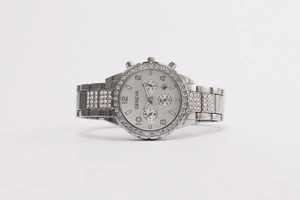 Detail of silver Geneva watch with rhinestone bezel and chronograph style dial