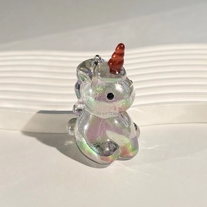 Macro shot of iridescent unicorn acrylic pendant with vibrant colorful UV plating finish