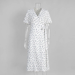 Close-up of white floral cotton midi dress with puff sleeves and wrap waist detail