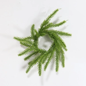 Detailed close-up of green Norfolk pine wreath napkin ring for Christmas table decor