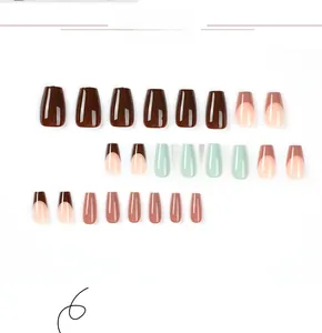 Detail view of brown French coffin press-on nails with glossy mint green accents