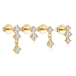Detail of four gold S925 sterling silver bow earrings set with white zircon stones
