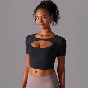 Detail of black mesh patchwork sports top with front cutout design for yoga and fitness