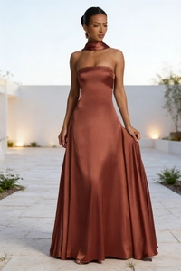 Detail of elegant brown satin backless maxi dress with matching neck scarf accessory