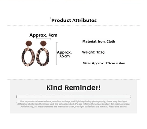 Detail view of oval leopard print fabric earrings with size measurements of 7.5cm by 4cm