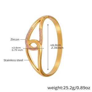 Gold stainless steel irregular crossover bangle with pink zircon stones and measurements