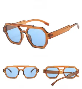 Detail view of octagon double-bridge sunglasses with orange frames and blue lenses