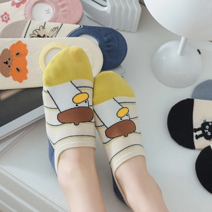Detailed view of colorful cotton low-cut socks with cartoon animal and flower patterns