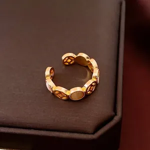 Retro hollowed gold open ring featuring white mother-of-pearl inlays in a round pattern