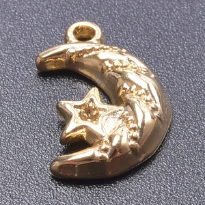 Macro shot of gold stainless steel crescent moon and star charm for DIY jewelry making
