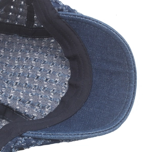 Close-up of denim beret interior featuring breathable mesh fabric and durable sweatband