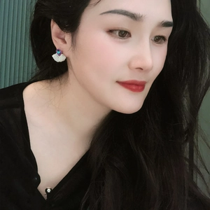 Detailed view of elegant fan-shaped crystal earrings worn by a model in profile
