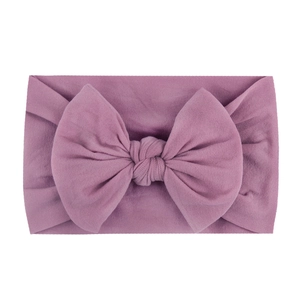 Lilac purple baby headband with soft ribbed nylon fabric and a large hand-knotted bow