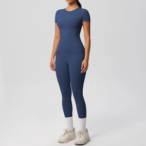 Full view of deep blue short-sleeved yoga set with high-waist leggings on model