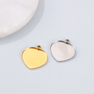 Detailed view of heart-shaped stainless steel pendant trays in gold and silver finishes