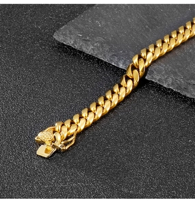 Macro shot of gold Cuban chain bracelet featuring a detailed lion head clasp design
