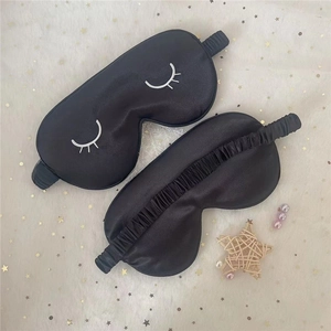 Detail of silk sleep eye mask with eyelash embroidery and elastic strap design
