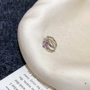 Detailed shot of irregular silver double-layered ring with purple marquise zircon