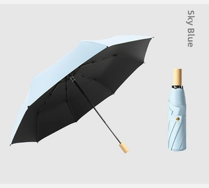 Sky blue folding umbrella with black sun protection coating and wooden handle